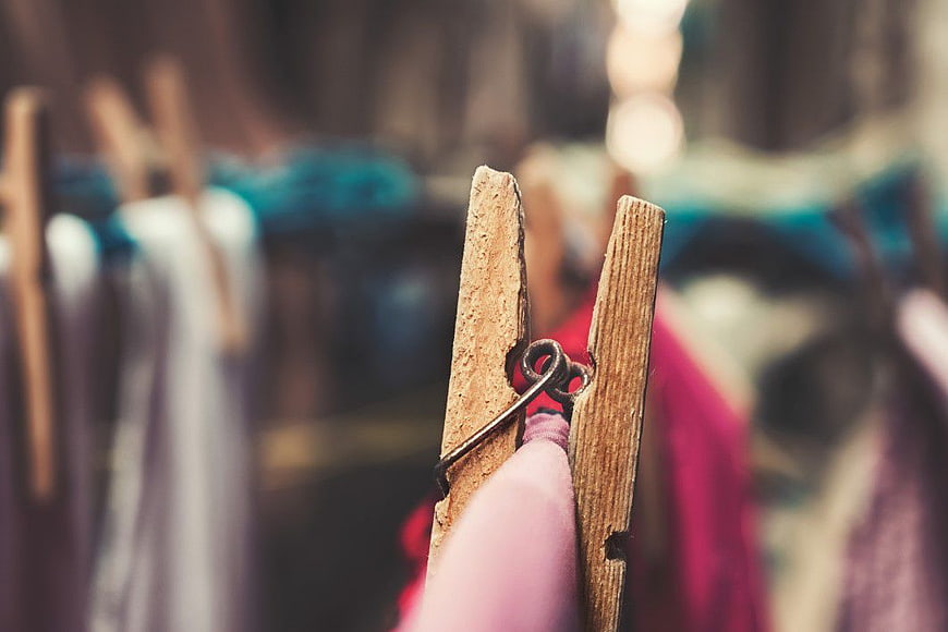 Close-up of wooden clothespin on colorful laundry