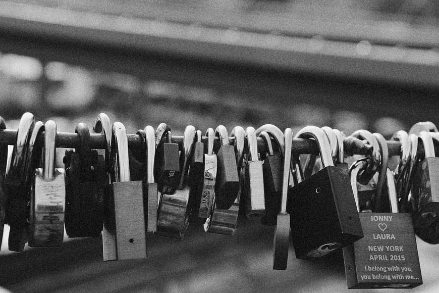 Black and white love locks on a bridge railing
