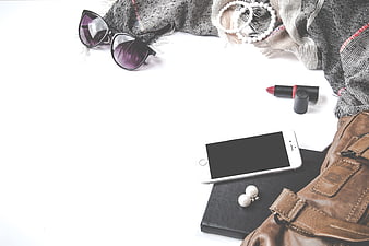 Flat lay of women's fashion accessories on white background