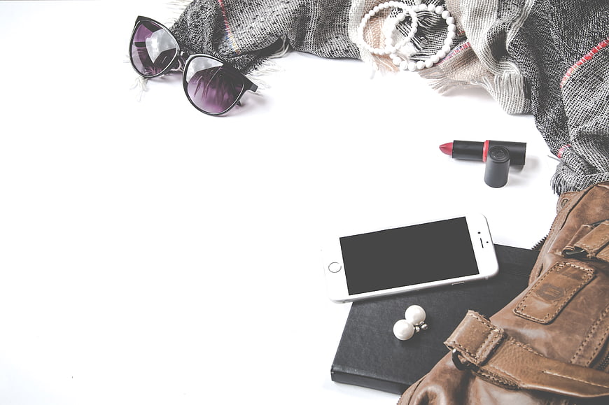 Flat lay of women's fashion accessories on white background