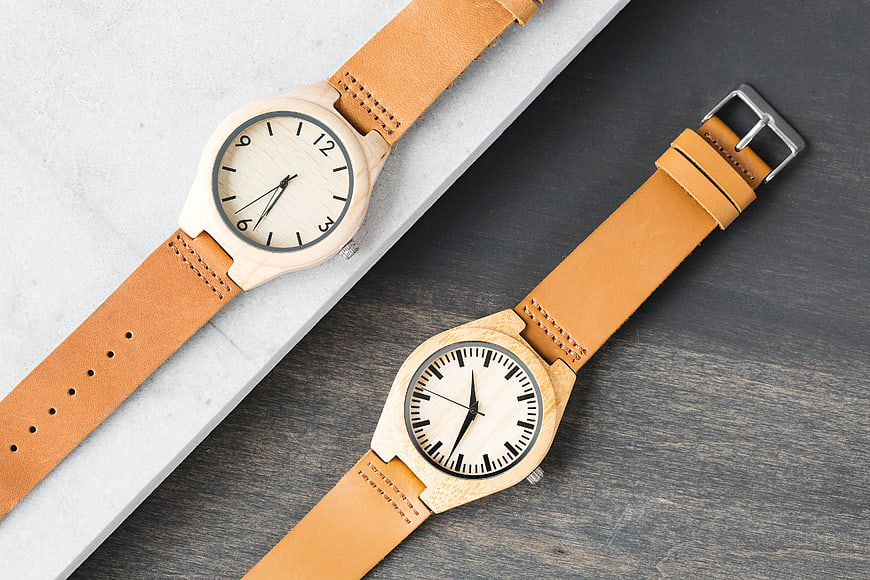 Wooden Watches with Leather Straps on Marble and Wood