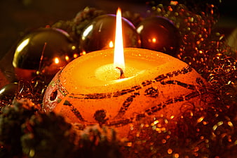 Lit Advent Candle With Christmas Ornaments And Glitter