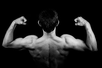 Muscular Man Flexing Back Muscles in Black and White