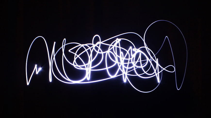 White Abstract Light Painting Scribble on Black Background