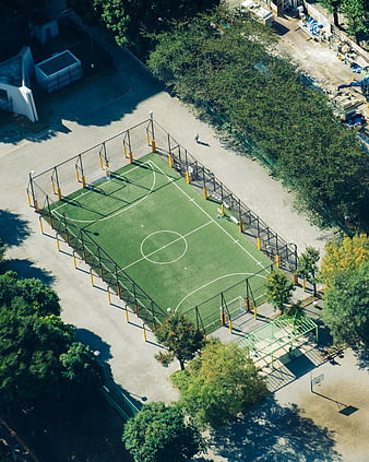 Aerial View of Green Soccer Field Surrounded by Trees