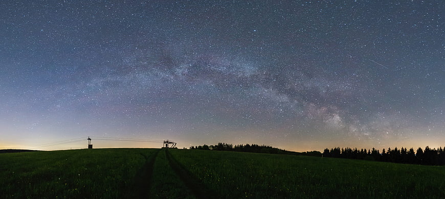 Panoramic Milky Way over Green Field at Night