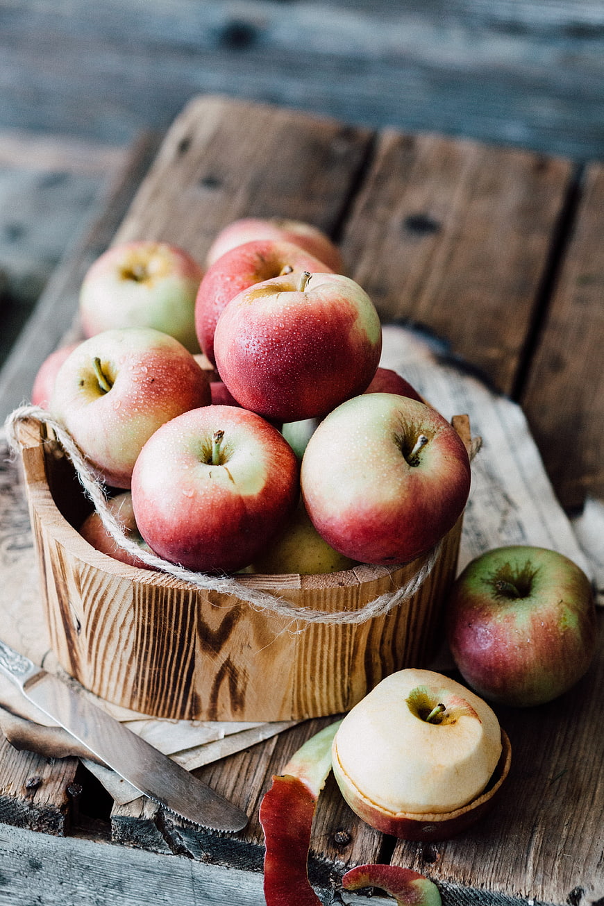 Fresh Red Apples in Wooden Bucket on Rustic Table