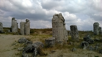 Ancient Stone Ruins Under Dramatic Cloudy Sky