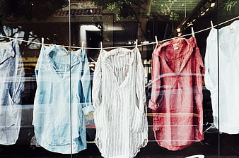 Colorful shirts hanging on a clothesline in a shop window