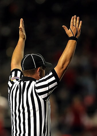 American Football Referee Signaling Touchdown from Behind