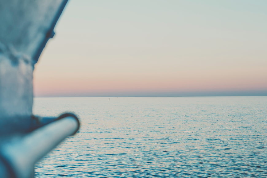 Serene Ocean Horizon at Dusk with Blurred Foreground