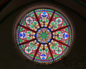 Circular stained glass window with floral patterns