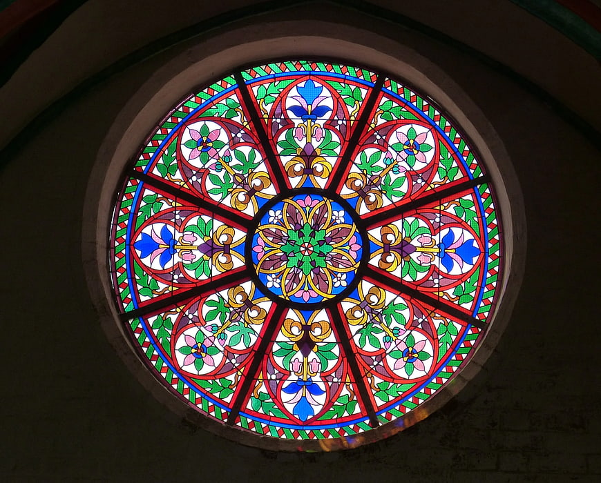 Circular stained glass window with floral patterns