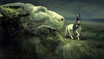 Fantasy woman on white horse near giant stone lion head