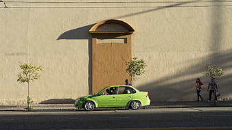 Green Car Parked on Street with Shadows