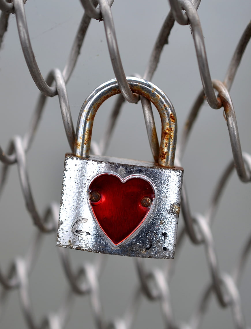Rusty Heart Padlock on Chain Link Fence