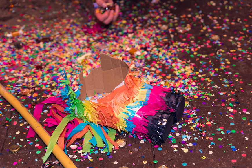 Broken Rainbow Piñata with Confetti and Candy on Floor