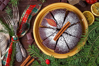 Christmas chocolate cake with festive decorations and pine branches