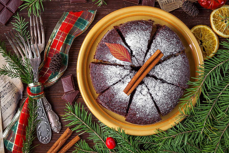 Christmas chocolate cake with festive decorations and pine branches
