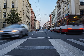 Motion blur traffic on European city street with bus and car