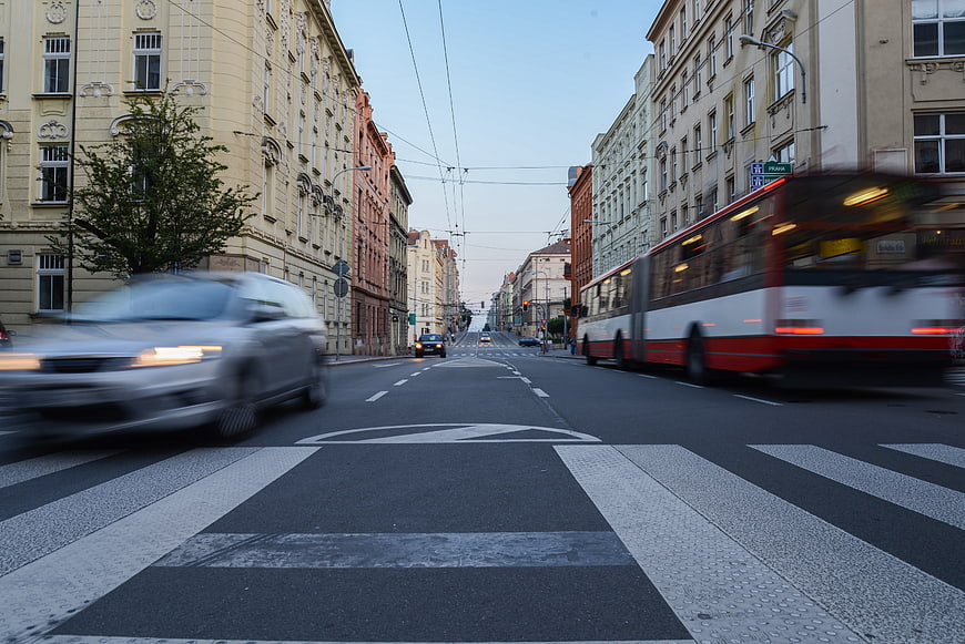 Motion blur traffic on European city street with bus and car
