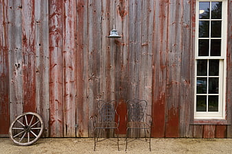 Rustic Barn Exterior with Vintage Chairs and Wagon Wheel