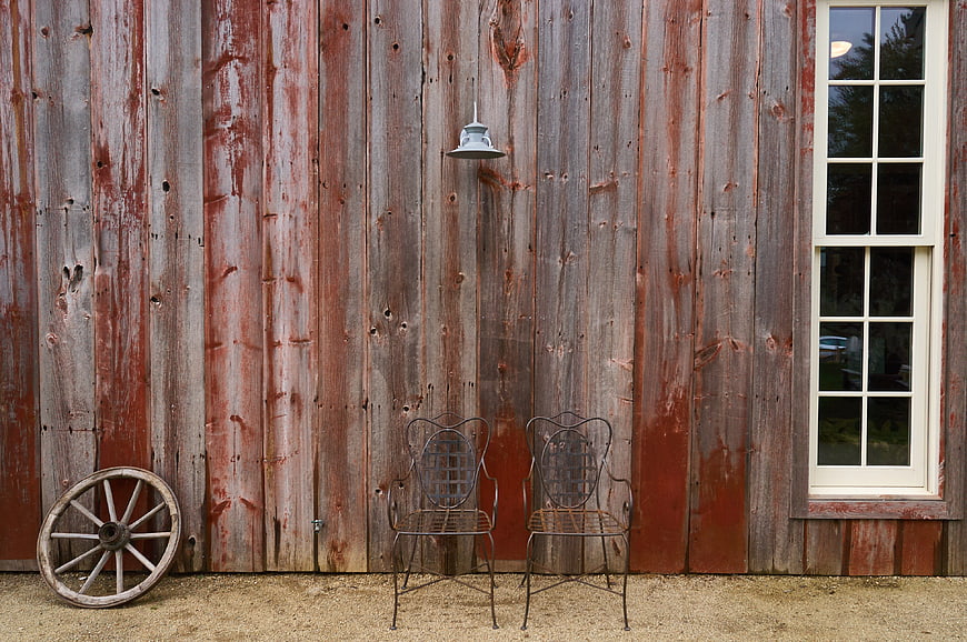 Rustic Barn Exterior with Vintage Chairs and Wagon Wheel