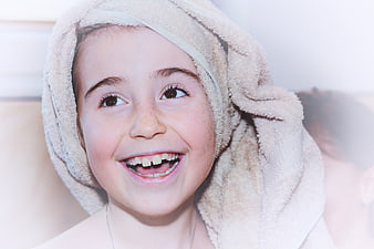 Happy Girl with Towel on Head Smiling Close Up