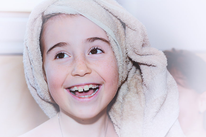 Happy Girl with Towel on Head Smiling Close Up