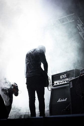 Silhouette of Rock Guitarist Performing on Smoky Stage