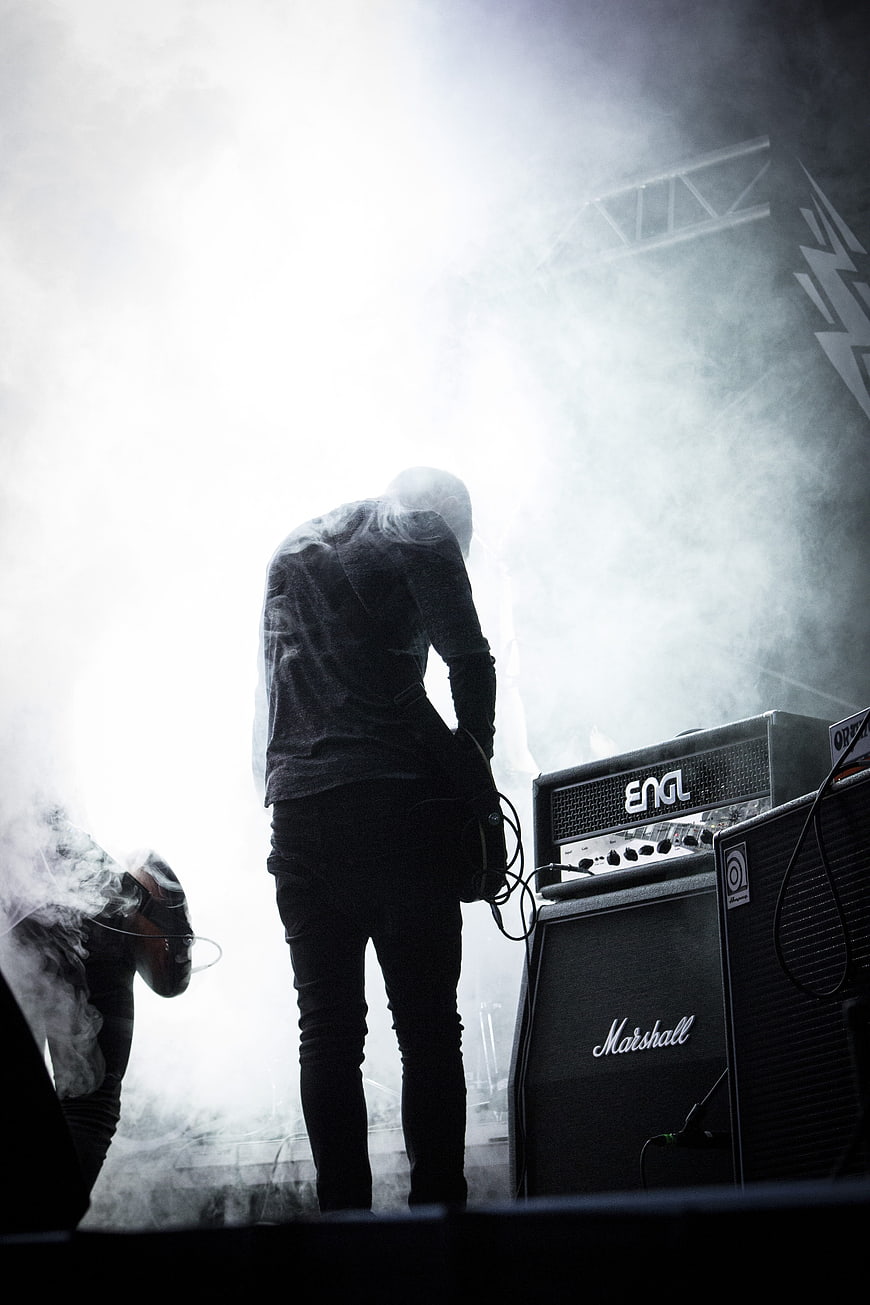 Silhouette of Rock Guitarist Performing on Smoky Stage