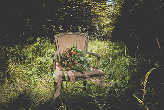 Vintage Chair with Wildflowers in Sunlit Forest