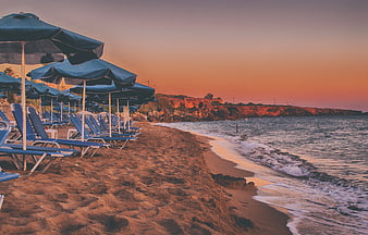 Sunset at Ammes Beach Kefalonia with Blue Umbrellas