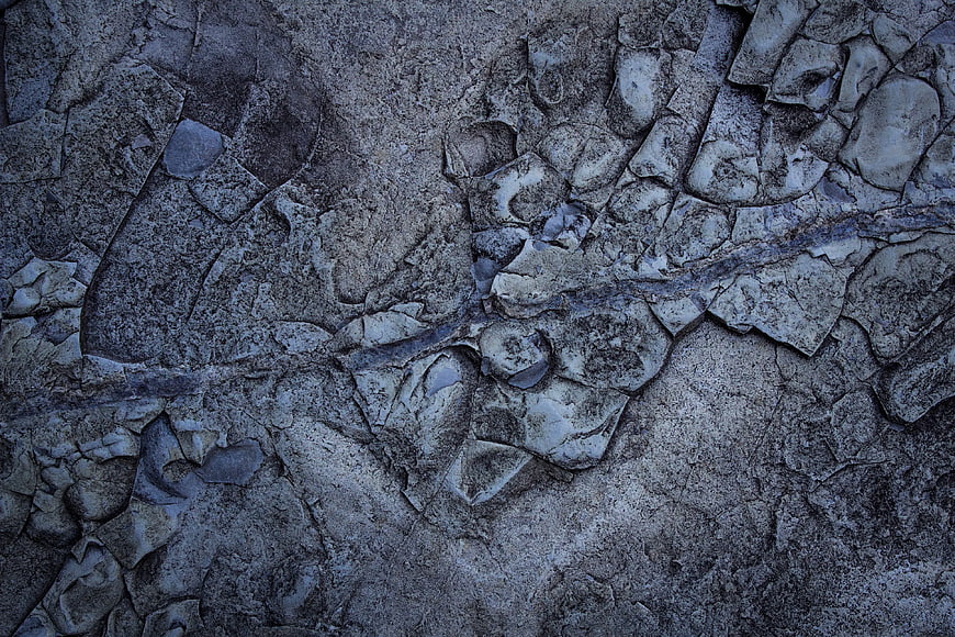 Aerial view of cracked gray and blue frozen lake surface
