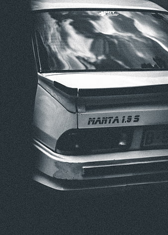 Rear view of classic Opel Manta 1.9S car in black and white