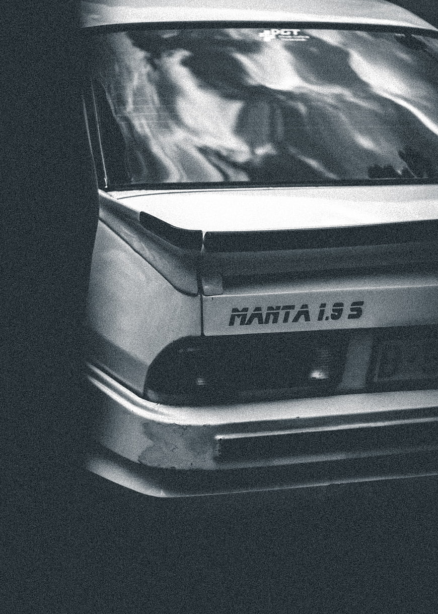 Rear view of classic Opel Manta 1.9S car in black and white