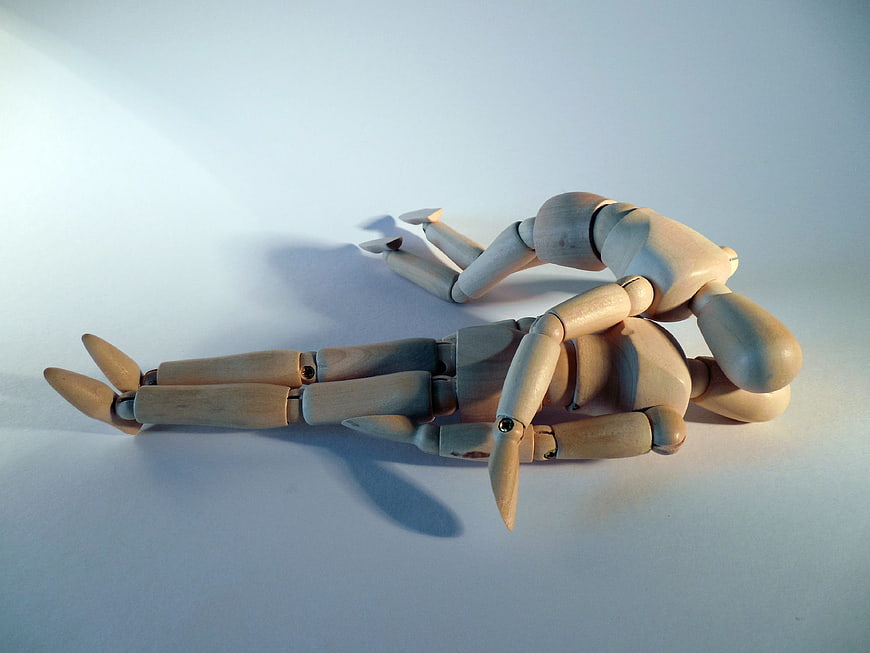 Wooden Mannequin Performing CPR on Another Figure