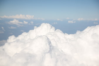 Aerial View Of Fluffy White Cumulus Clouds In Blue Sky