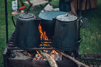 Vintage camping cookware on open fire grill