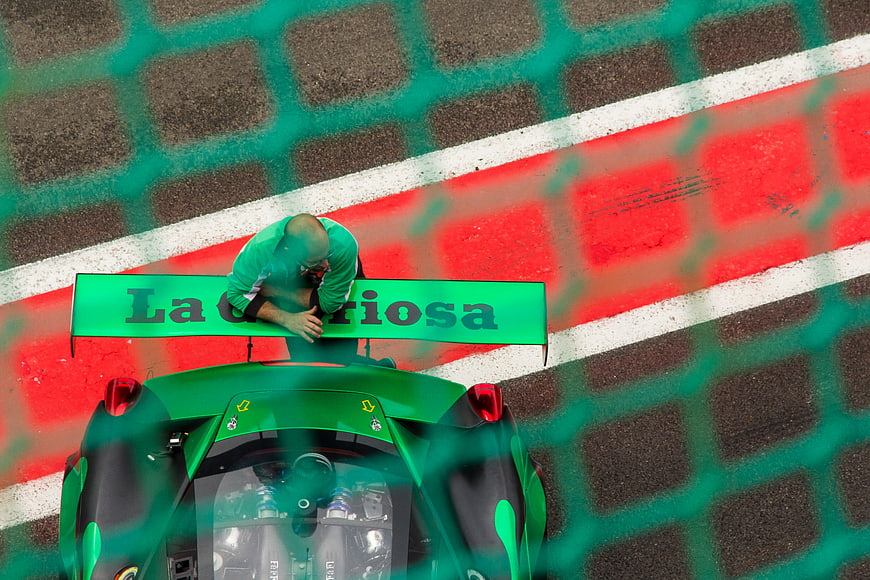Top down view of green race car on track