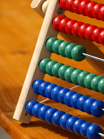 Close-up of colorful wooden abacus beads on a desk