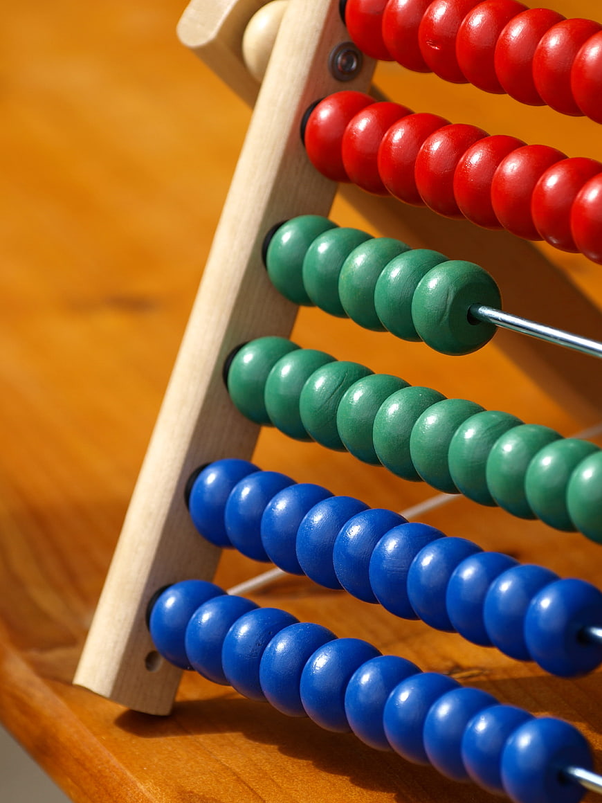 Close-up of colorful wooden abacus beads on a desk