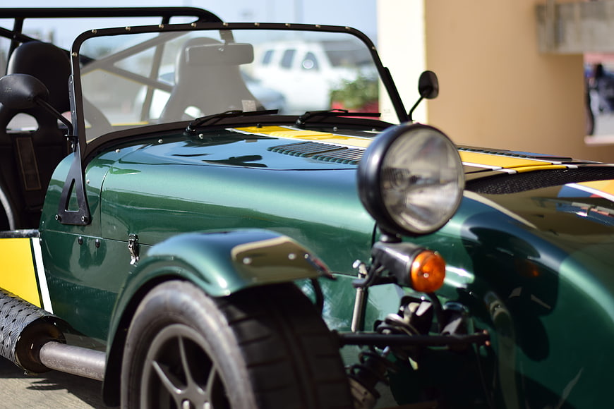 Close-up of Green Classic Sports Car with Yellow Stripes