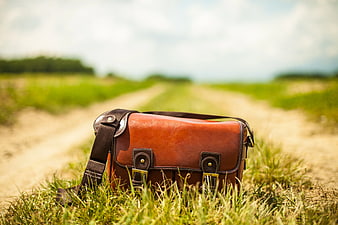 Brown Leather Messenger Bag on Grassy Path