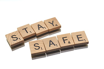 Wooden Scrabble Tiles Spelling Stay Safe on White Background