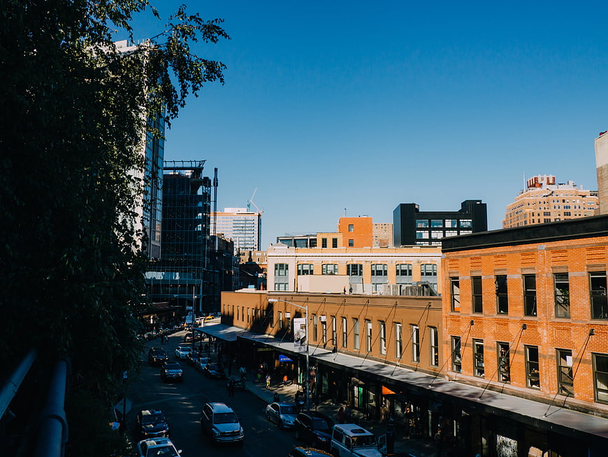 Urban Street Scene with Brick Buildings and Blue Sky