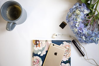 Flat Lay Workspace with Coffee, Flowers, and Smartphone