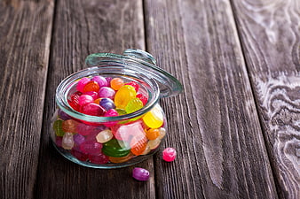 Colorful Jelly Beans in Glass Jar on Wooden Table