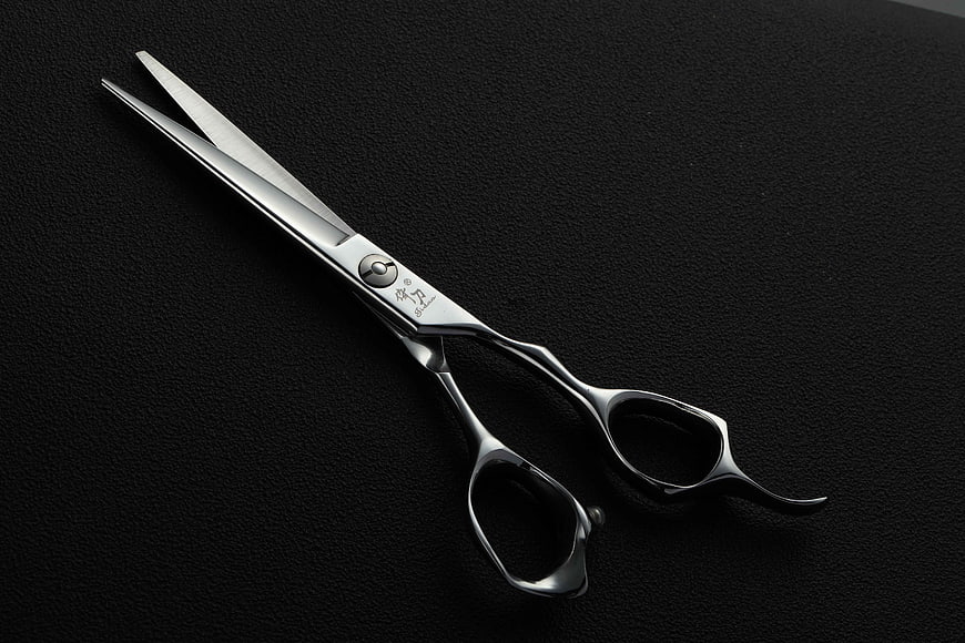 Professional Silver Hairdressing Scissors on Black Textured Background