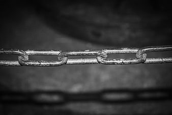 Close-up of metal chain links with shadow